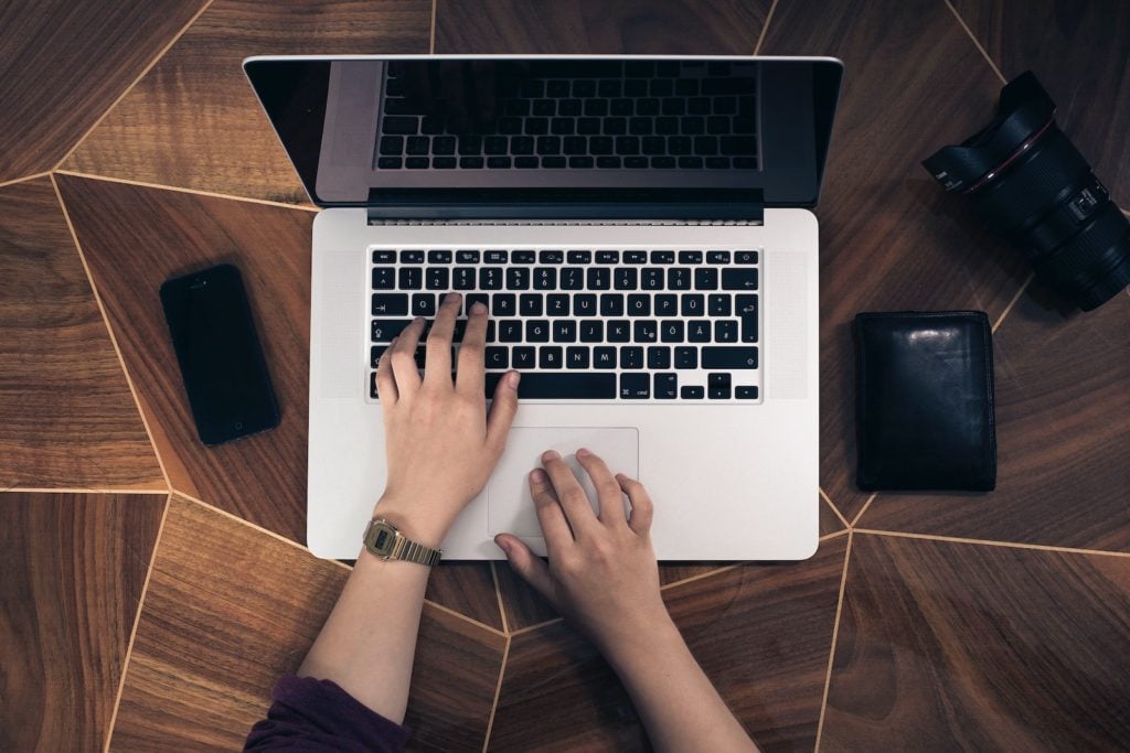 Image of person typing on laptop