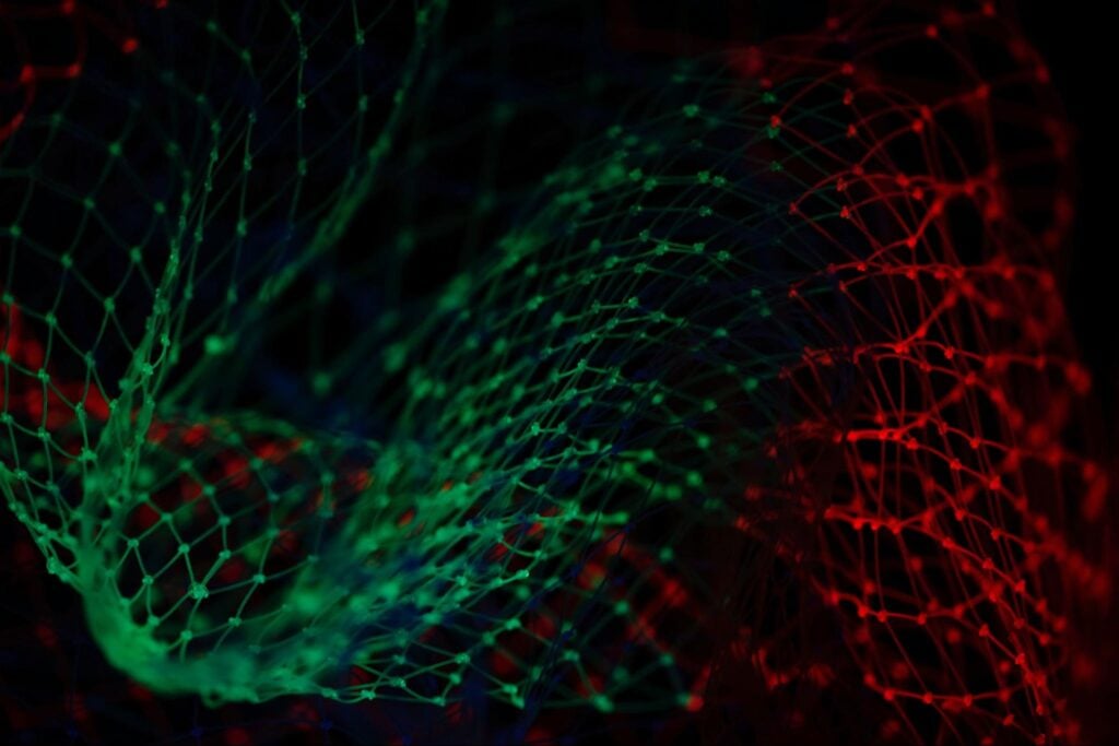 Static image of black background and green and red netting.